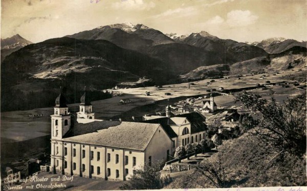 Blick auf Kloster und Dorf Disentis mit Oberalpbahn Vorderseite